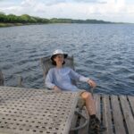 Travel - Cathie Lounging on Dock at Lamanai Outpost Lodge in Belize (1) Medium