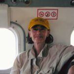 Travel - Cathie in Her Devo Hat on a Small Plane Medium